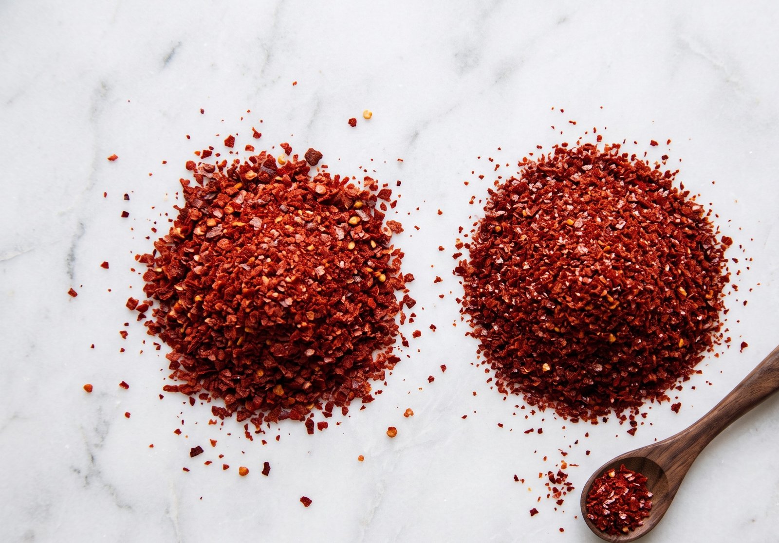 Gochugaru flakes beside Aleppo pepper flakes for comparison